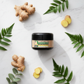 ADJANISS Thickens Hair Cream – white marble flat lay with ginger and botanicals