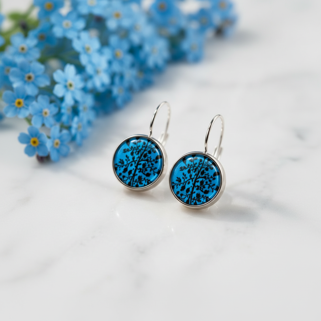 Teal blue Tree of Life earrings on marble with blue forget-me-not flowers