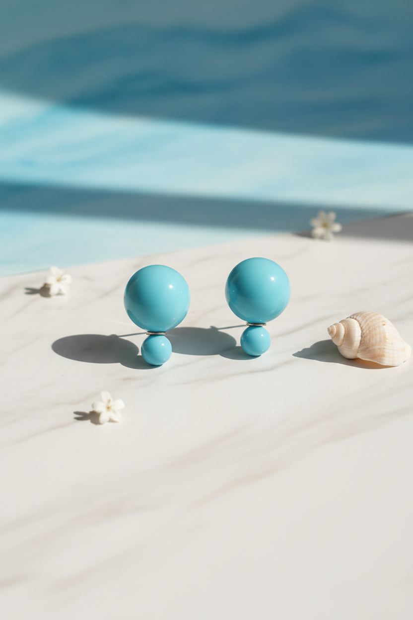 Sky blue double ball earrings hero shot on white marble with coastal styling